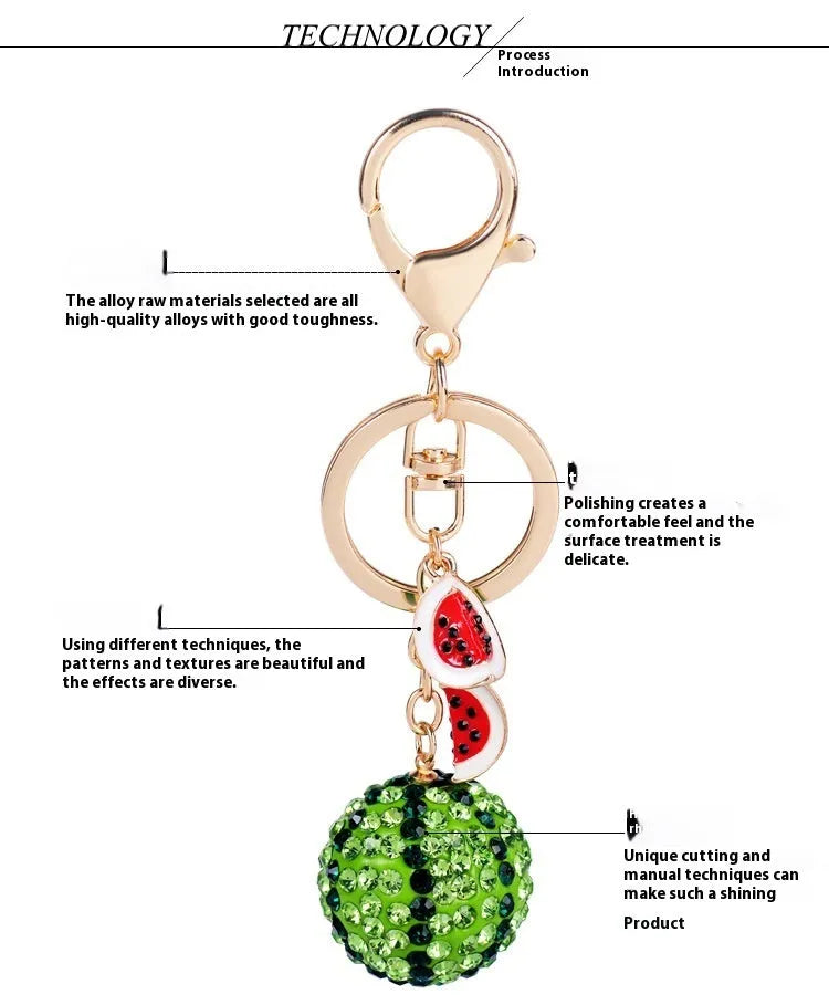 Green watermelon-shaped metal keychain with sparkling crystal details on a white background.