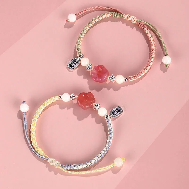Handmade red cat's paw charm bracelet with woven band in pink or yellow colour for couples