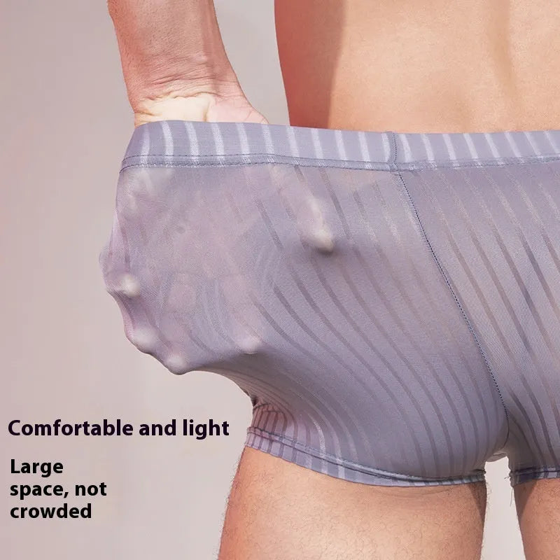 Men's thin striped nylon underwear in black, dark grey and white colours laid flat.