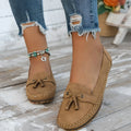 Women's suede flat shoes with a bow, shown in apricot colour, on a white background