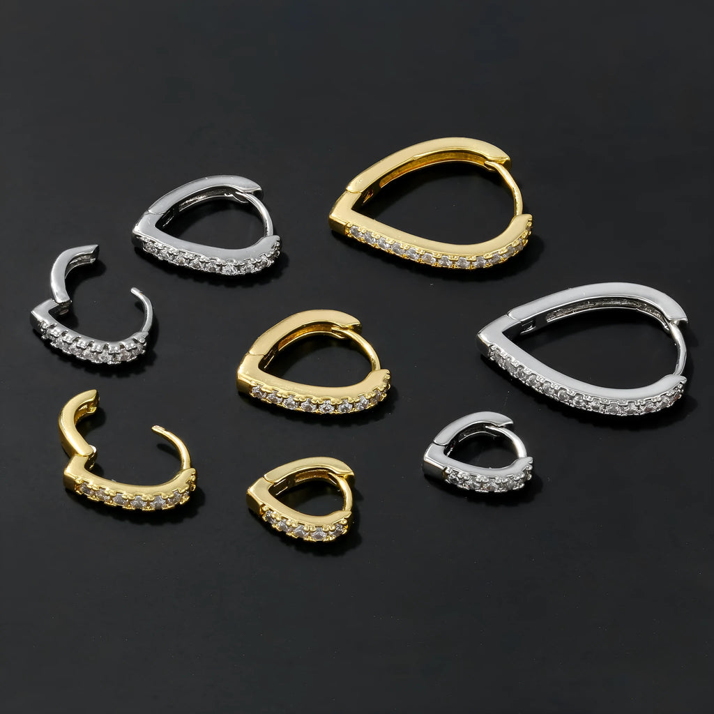 A geometric heart-shaped ear clip in a gold electroplated finish on a copper base.