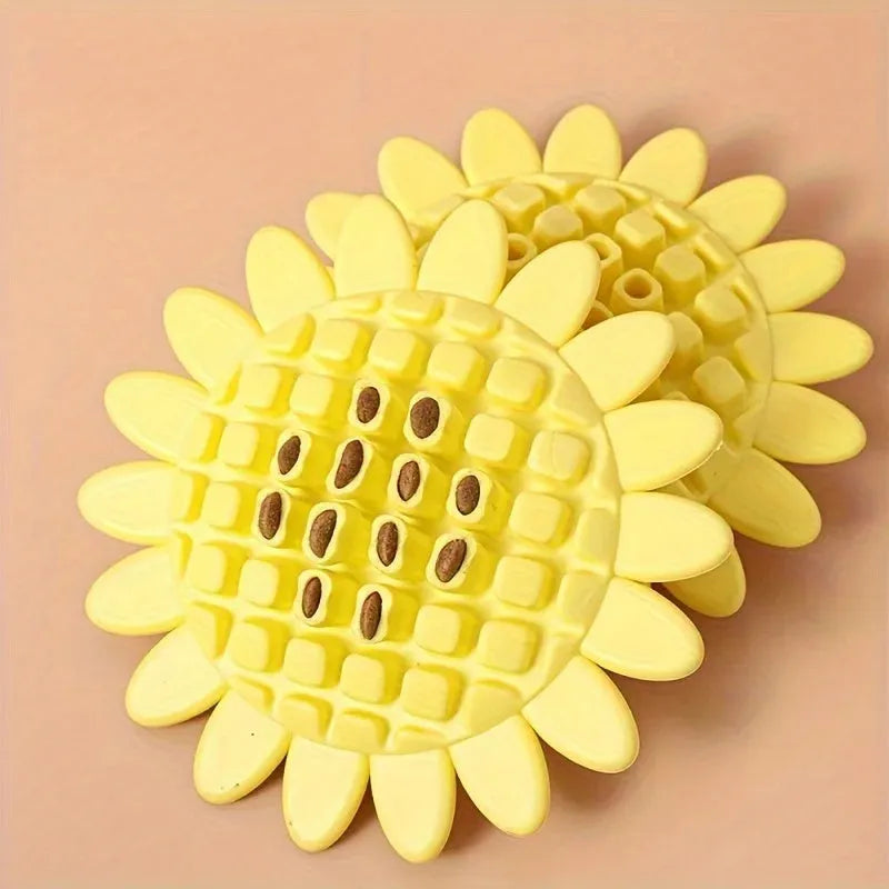 Yellow rubber sunflower dog chew toy with green stem, shown on a white background.