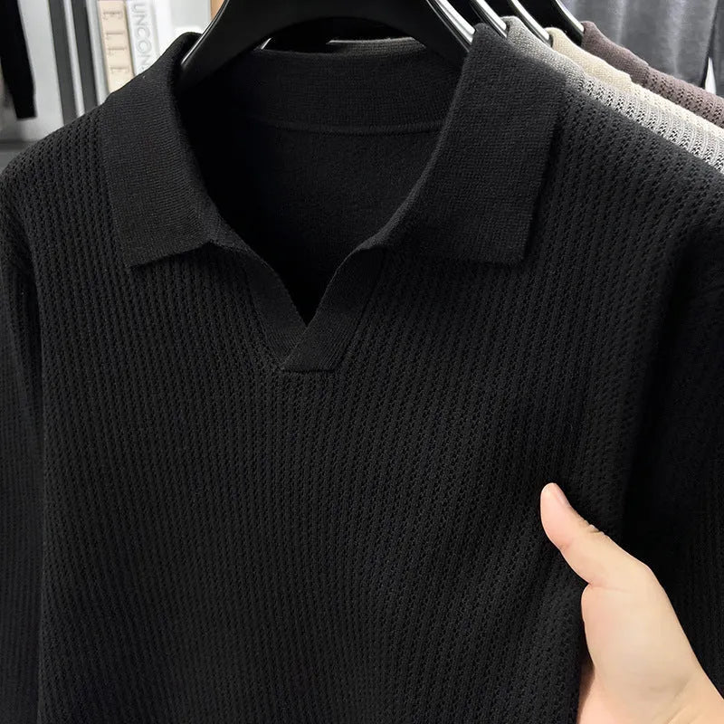 Man wearing a loose-fit green pullover sweater, a casual autumn garment.