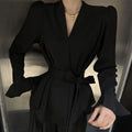 Women's black French-style shirt with an irregular collar and long bell sleeves.
