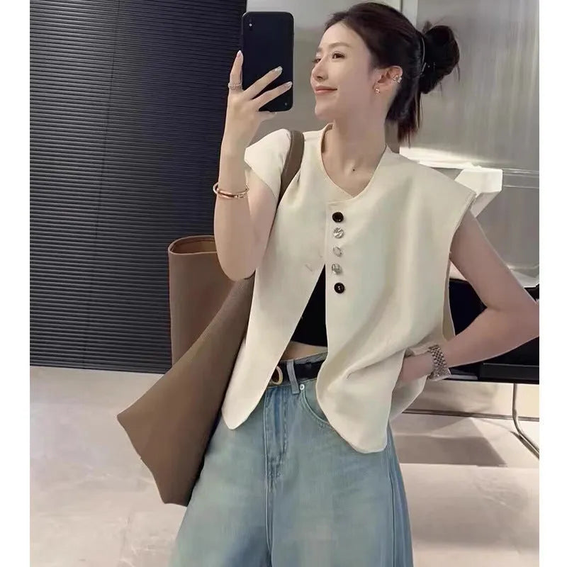 Women's loose-fit short vest in polyester, shown in milk white with side pockets.