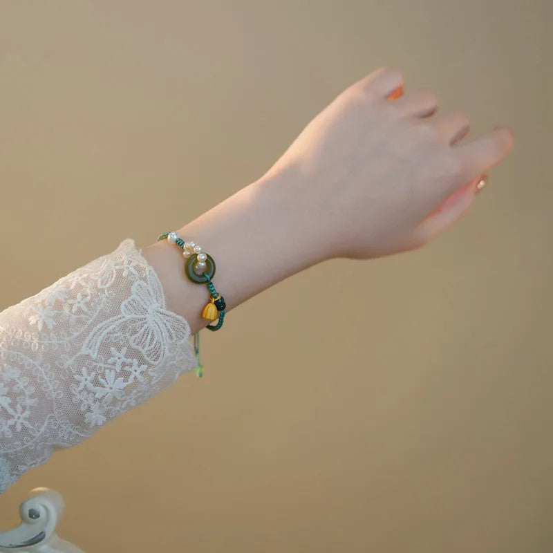 Hand-woven flexible wire watch band with a pearl peace buckle closure