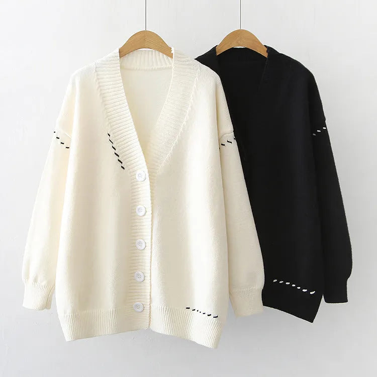 Women's loose-fit knitted cardigan top coat in black or white.