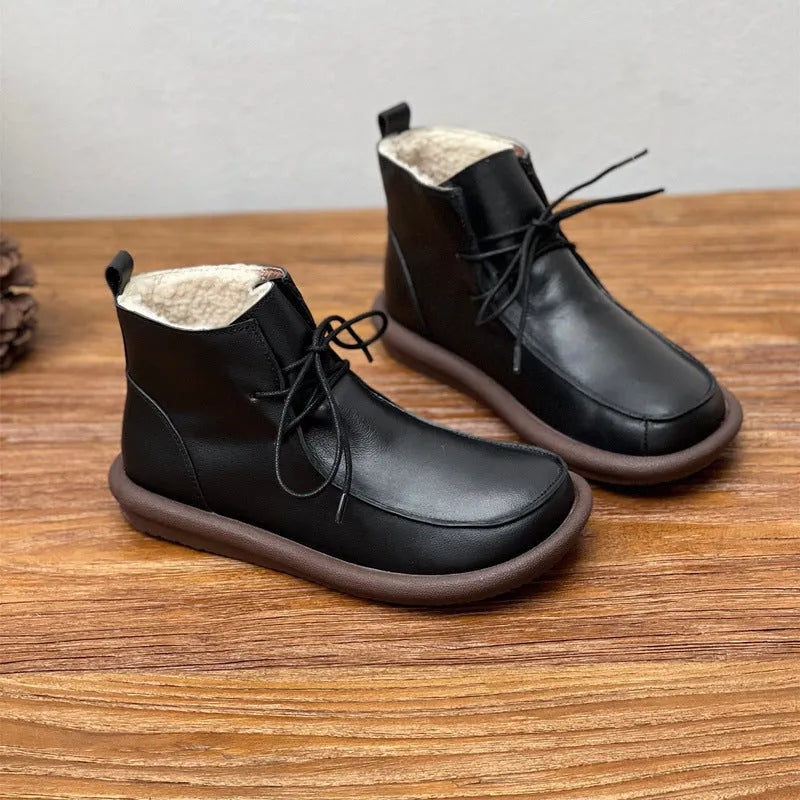 Women's casual cowhide boots with velvet lining in black and coffee colours showing round toe and flat heel design