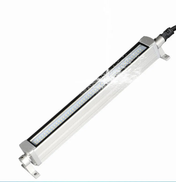 Long aluminium LED explosion-proof light strip with tempered glass cover for CNC lathe mounting.