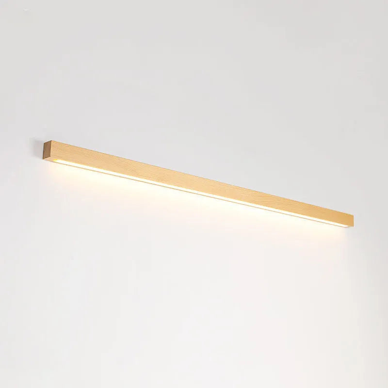 Walnut-coloured wooden log strip LED wall lamp with acrylic diffuser in minimalist design.
