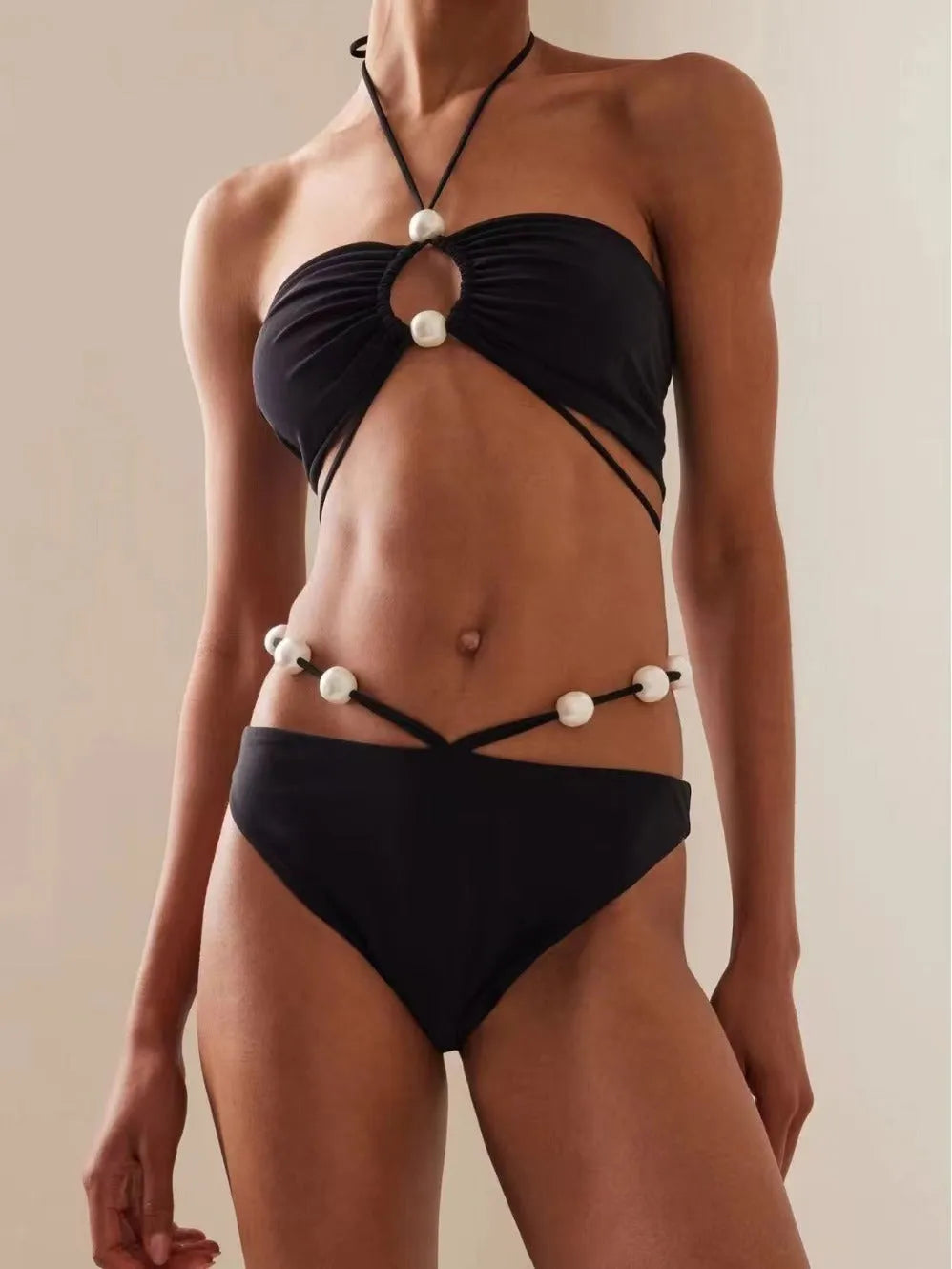 Women's black lace-up bikini swimsuit set with bra and shorts on white background
