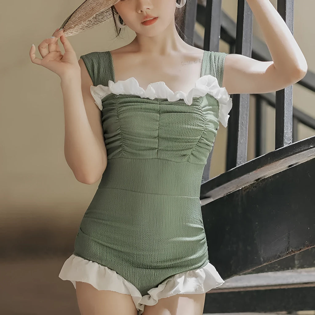 High-waist one-piece swimsuit in Korean style with slimming design available in black, pink, or green colours