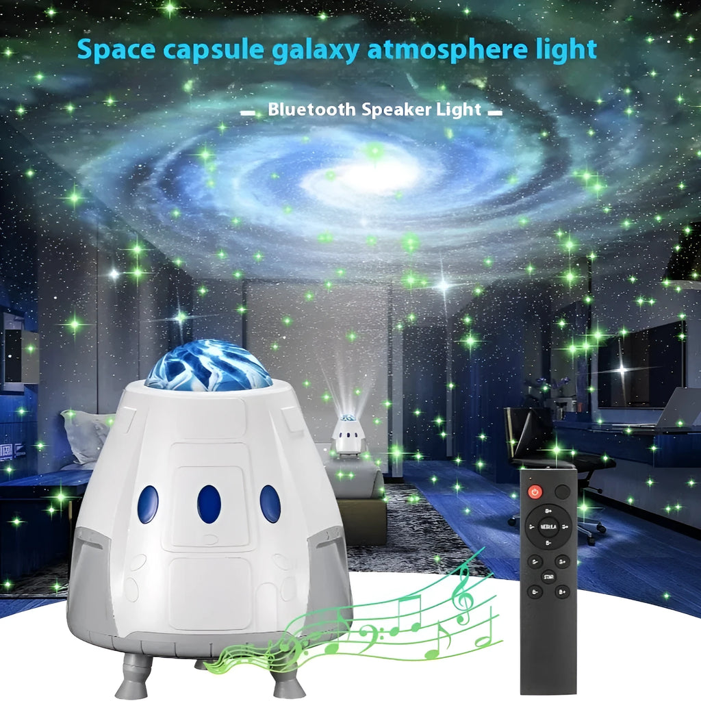 Tall white space capsule galaxy projection lamp with USB cable and remote control on a table.