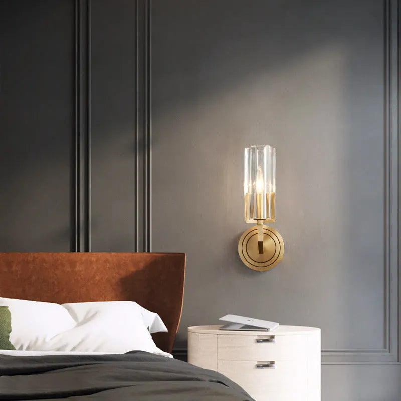 Modern minimalist copper wall lamp with single head on a plain wall.