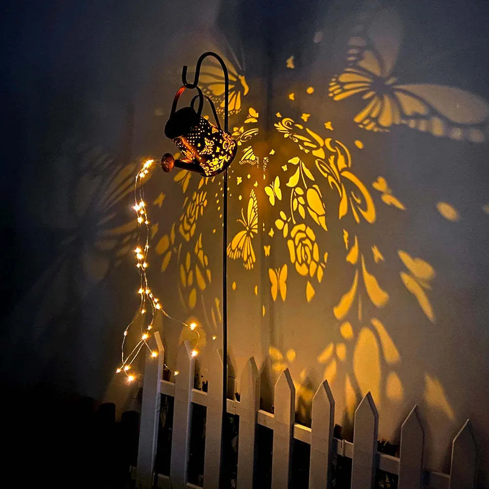 Solar garden lamp with iron tapered butterfly design emitting warm white LED light