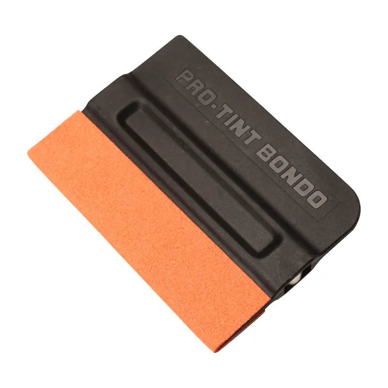 Car film application scraper tool with magnetic head and ABS handle on a work surface.
