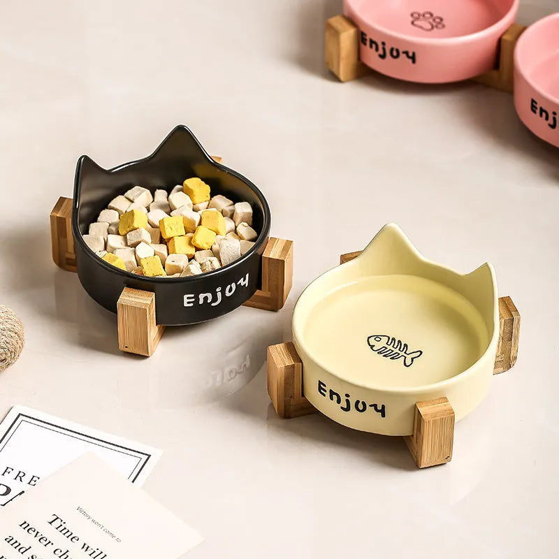 Porcelain cat bowl with wooden anti-tumble frame in pink with cat paw design