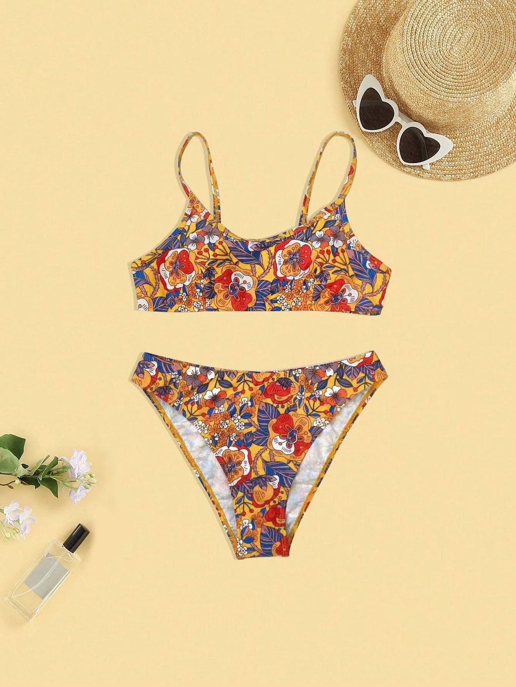 Plus size women's floral print strap bikini swimsuit two-piece set on a mannequin