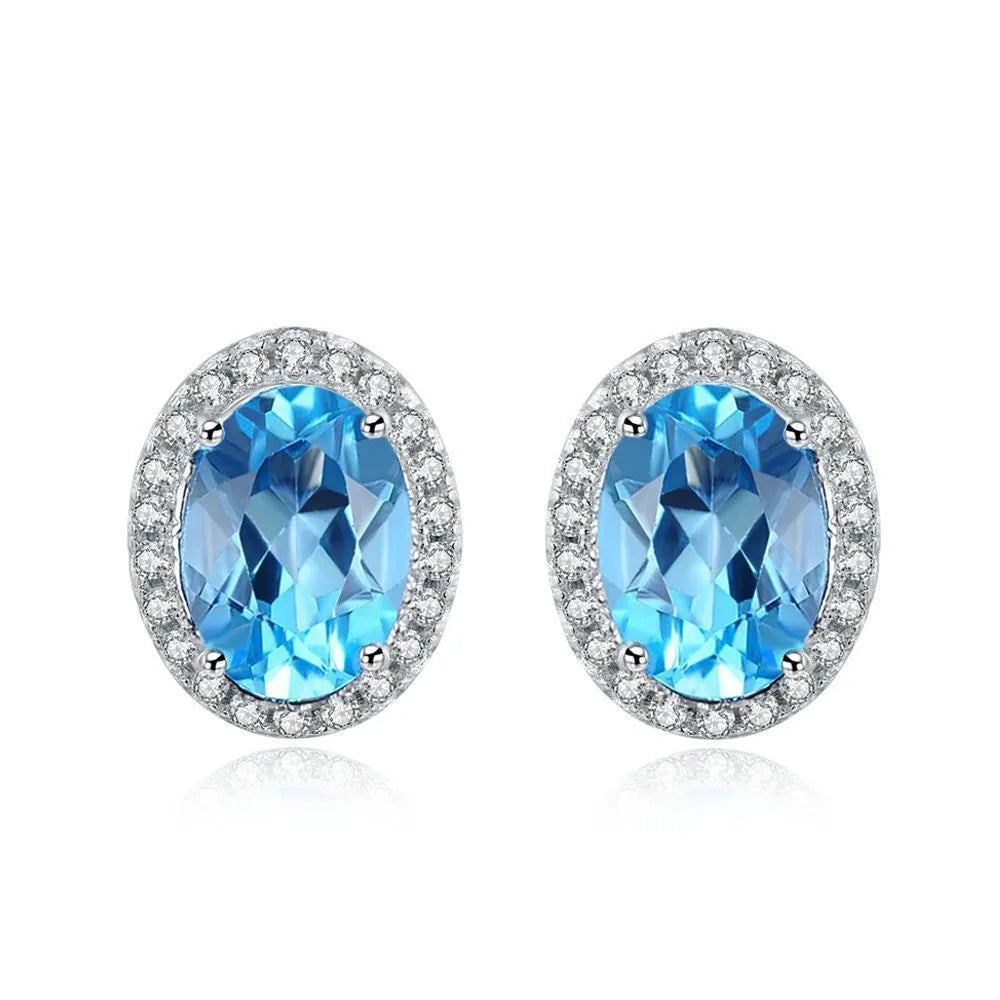 925 sterling silver geometric jewellery set with blue topaz gems showing earrings, ring, necklace, and pendant