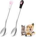 White and black stainless steel pet food spoons with cat paw print and silicone handle grips.
