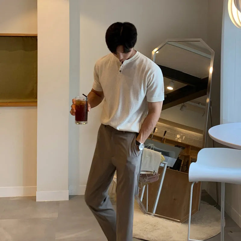 Man wearing a slim-fit black short-sleeved ice silk knitted pullover shirt.