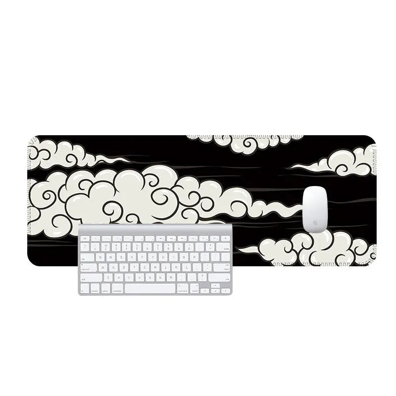 Large black desk mat with Japanese minimalist graphic pattern on a wooden desk, next to a keyboard and mouse.