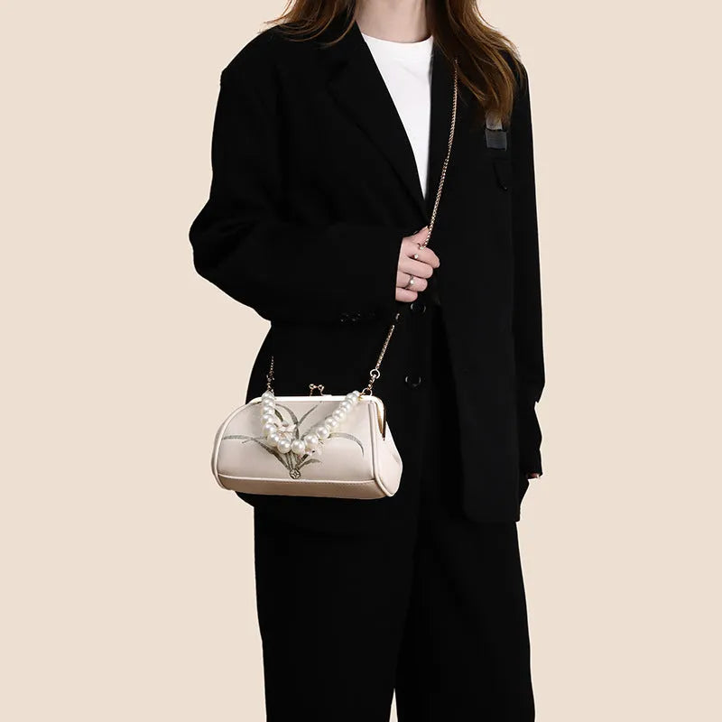 Beige women's shoulder bag with floral embroidery on soft PU leather material