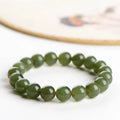 Polished Hetian jade ball bead bracelet in clear colour on wrist, showing spherical beads.