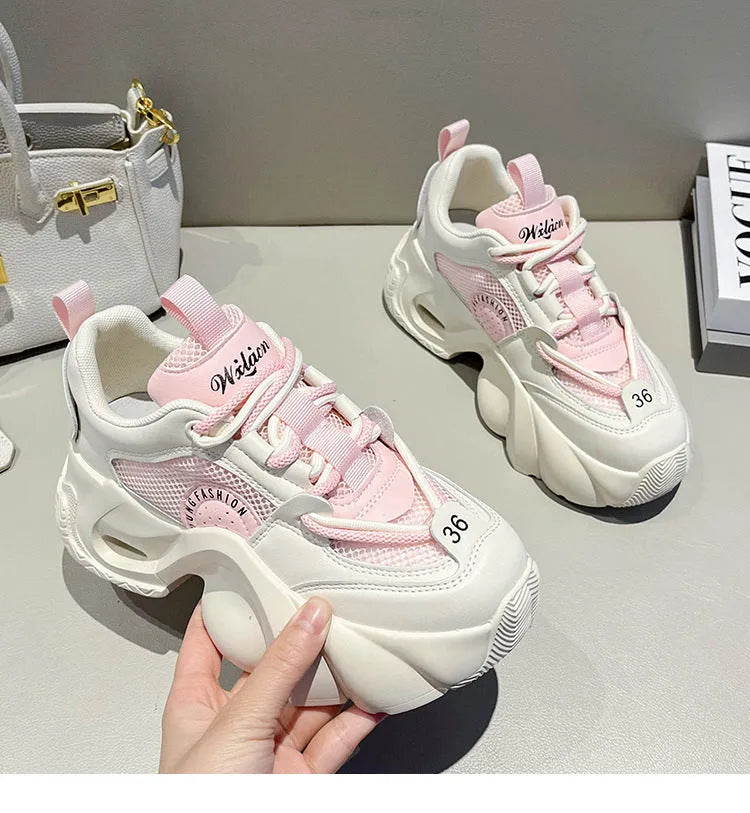 Women's pink sneakers with cross strap design and thick platform sole