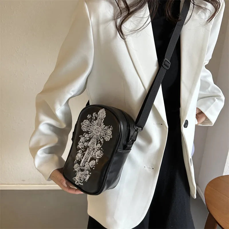 Women's black mini crossbody bag with orange Halloween pumpkin graffiti print.