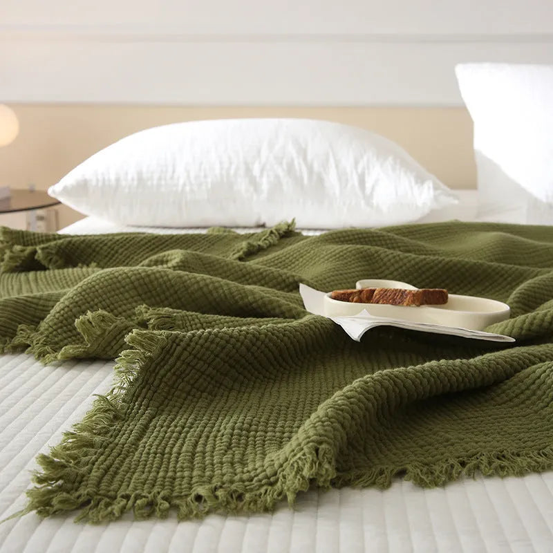 Four-layer gauze cotton blanket with edge tassels in a choice of ten colours and two sizes.
