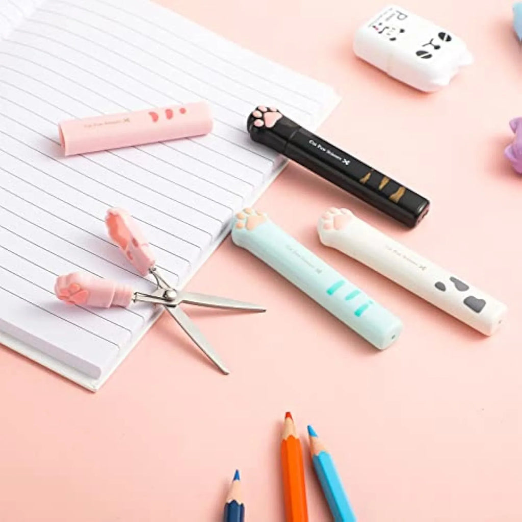 Closed and open views of cute cat paw design mini folding safety scissors on a craft background.