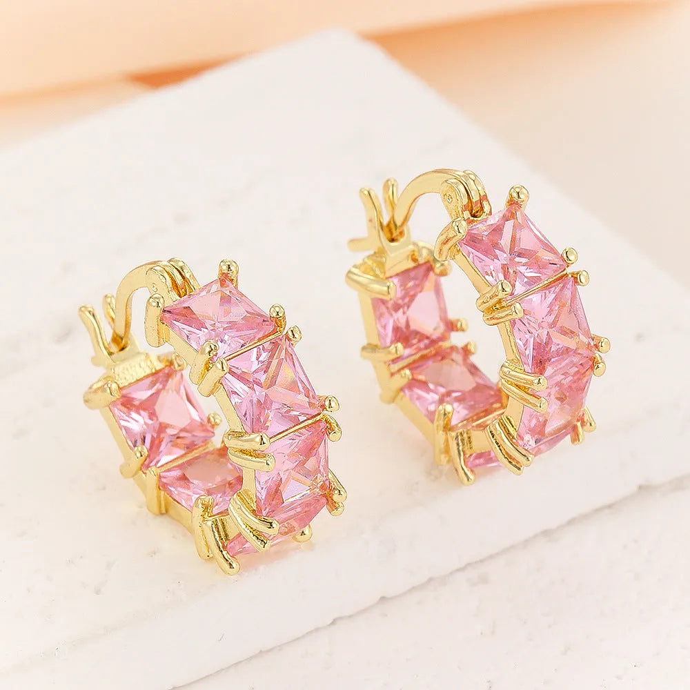 Geometric U-shaped drop earrings with zircon stones in black, pink or white colours on gold electroplated copper