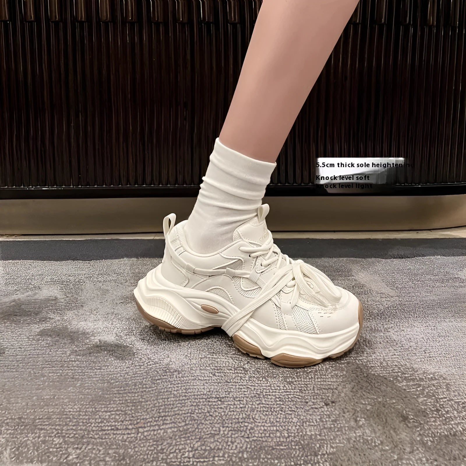 Beige women's casual sneakers with a platform heel and round toe, showing lace-up front.