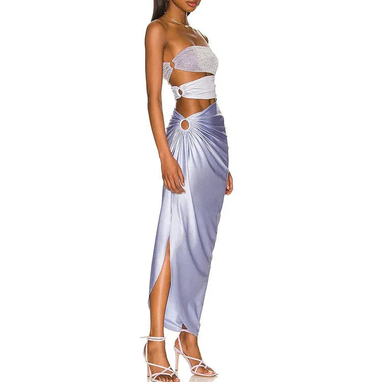 Purple one-piece swimsuit and matching wrap skirt set on a hanger.