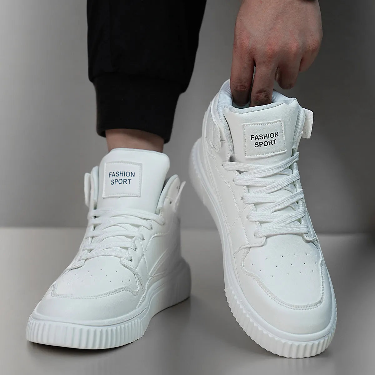 Men's white round toe casual shoes with a microfibre upper on a plain background.