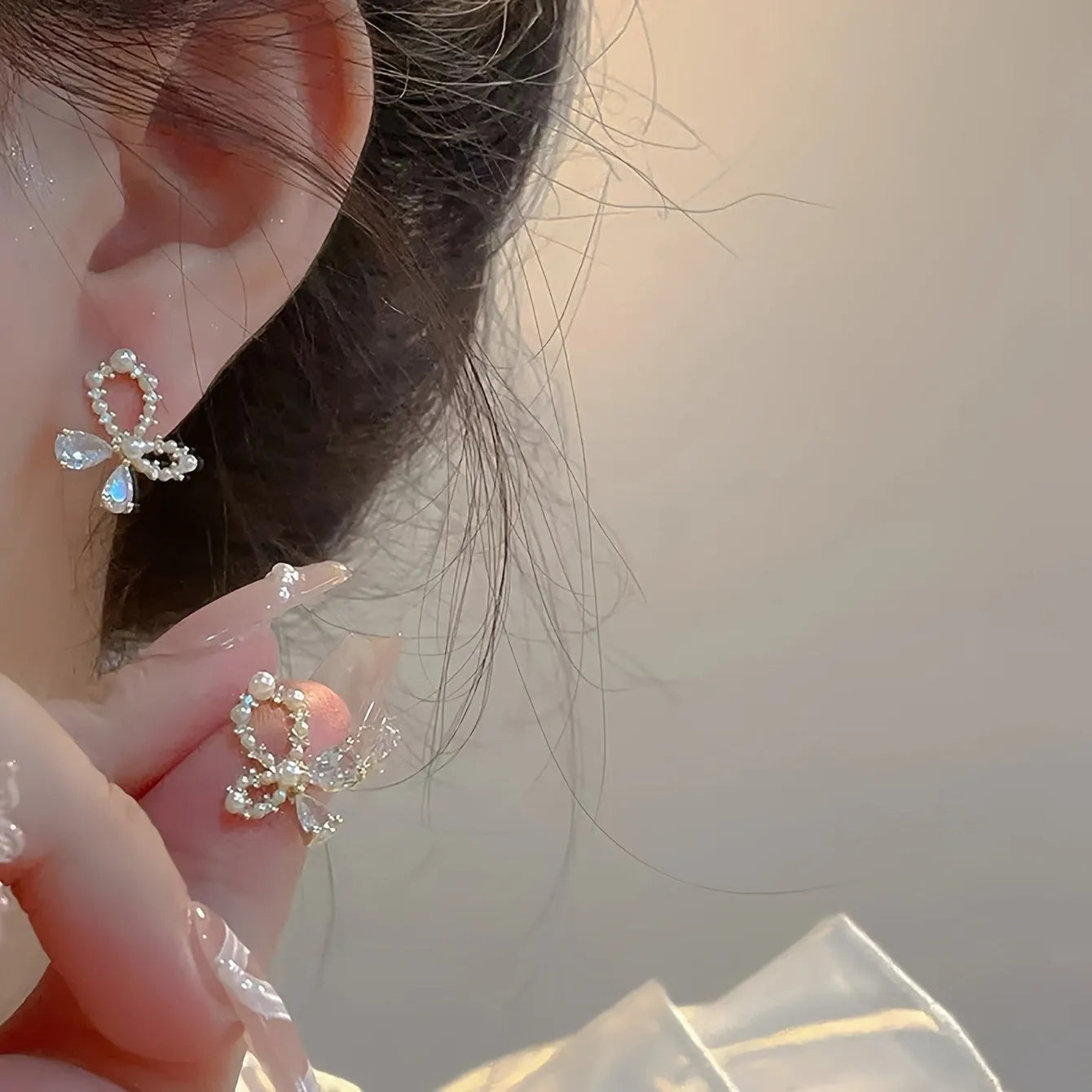 Silver electroplated copper butterfly earrings with geometric accents on a white background