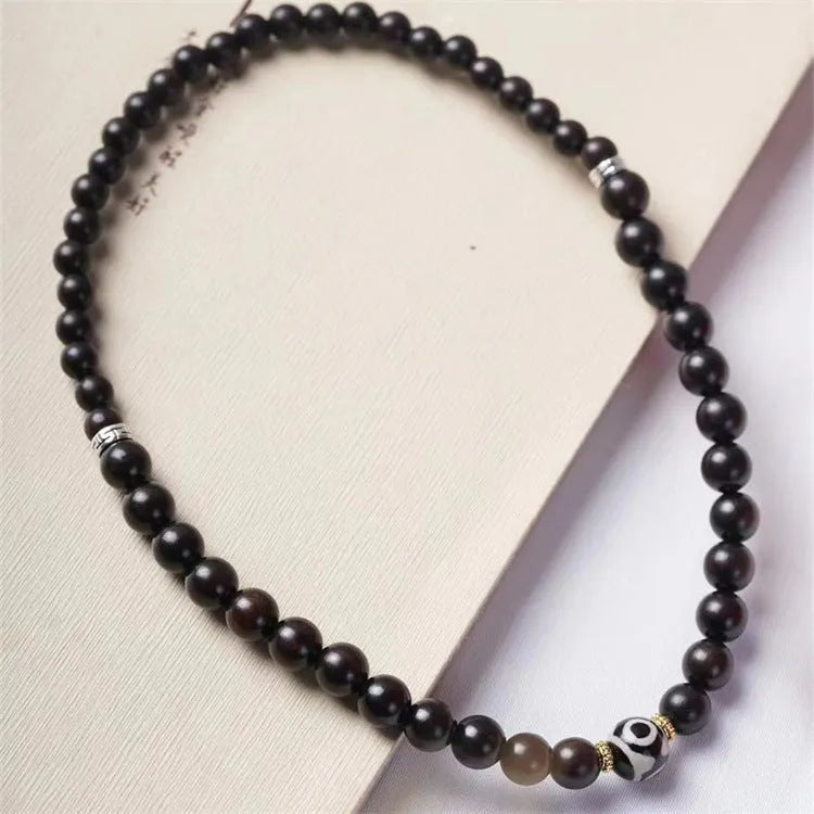 Ebony wood Tibetan prayer bead bracelet showing 8mm diameter and natural wood grain