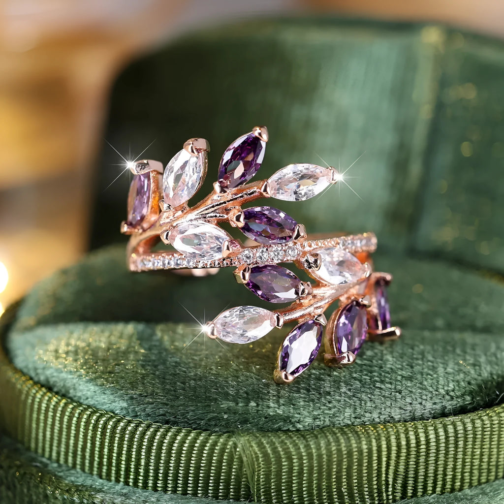 Adjustable open-ended leaf-shaped ring with zirconia stones on a copper band.