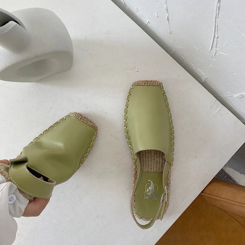 Women's beige canvas baotou flat sandals with a retro fisherman style on a plain background.