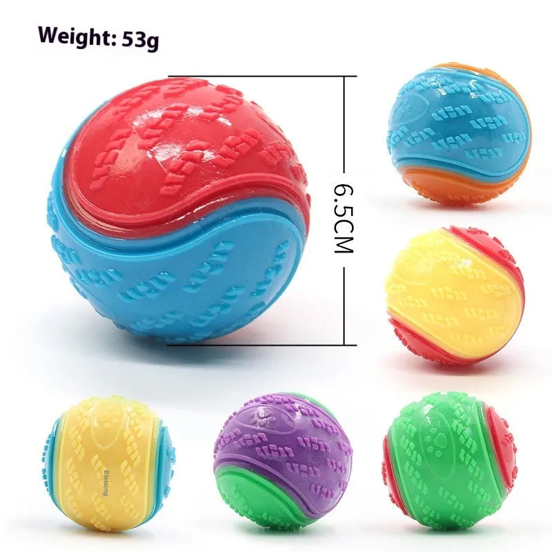 TPR dog training ball with squeaker in bright two-tone colours, showing molar texture on surface.