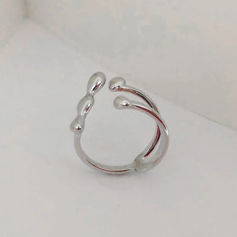 Brass spherical ring with circular design elements in gold or silver finish