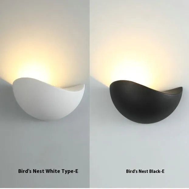 Black bird's nest design outdoor waterproof LED wall lamp with IP65 rating mounted on a wall.