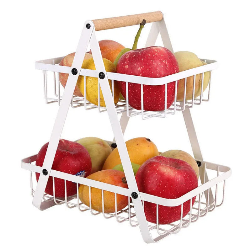 Black detachable double-layer iron fruit basket with a wooden carry handle on a tabletop.