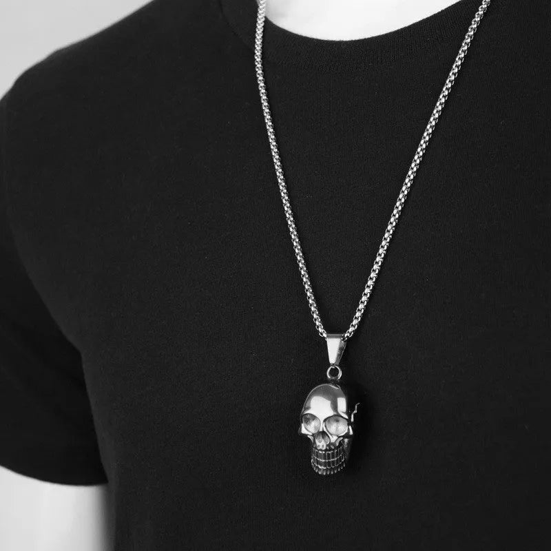 Halloween skull necklace in alloy and stainless steel with gold colour option on a black background