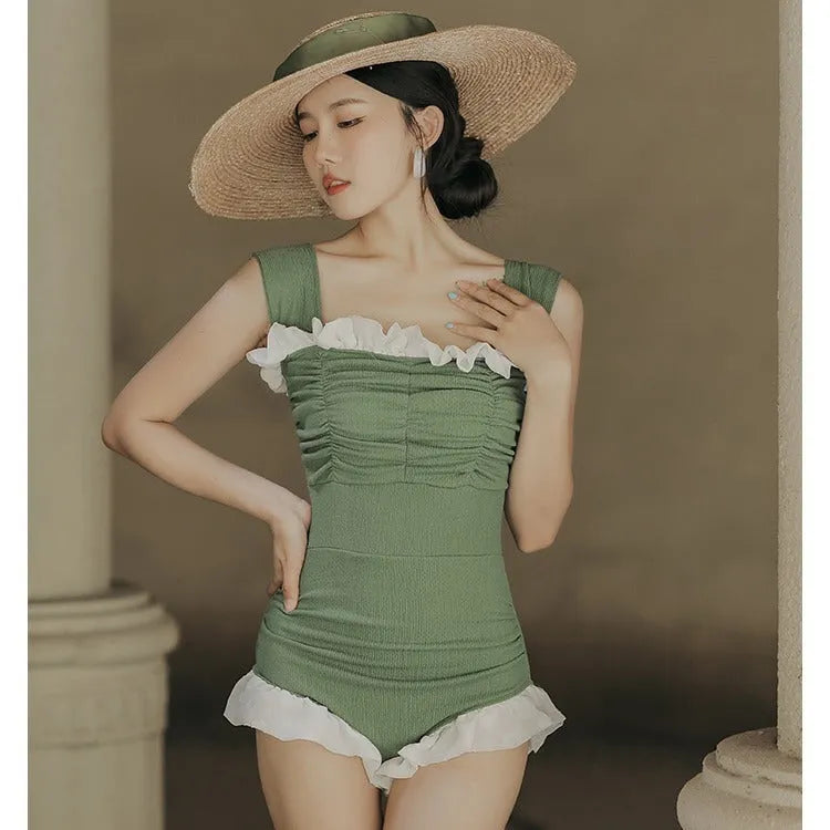High-waist one-piece swimsuit in Korean style with slimming design available in black, pink, or green colours
