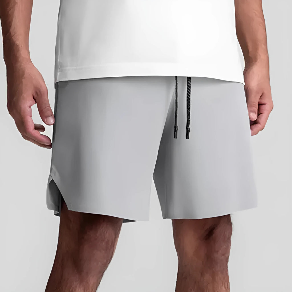 Men's grey seamless sports shorts with knee-length straight-leg cut on a plain background