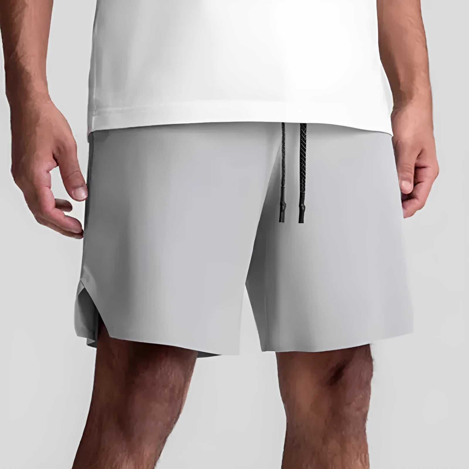 Men's grey seamless sports shorts with knee-length straight-leg cut on a plain background