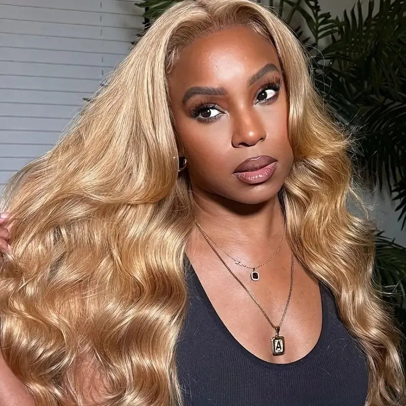 Light brown synthetic wig with big wave curls and side bangs in a long length.