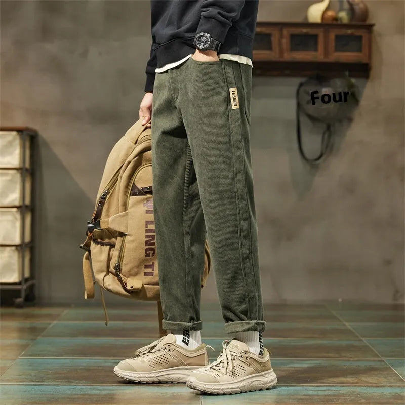 Men's army green corduroy casual trousers with a tapered straight-leg fit on a mid waist.